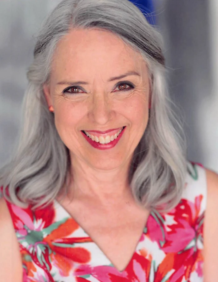 Mannette Antill, actor headshot in a floral dress