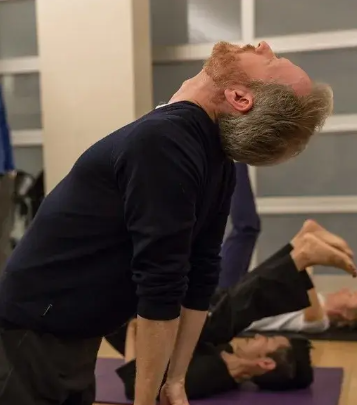 a student arching back in release, before sound